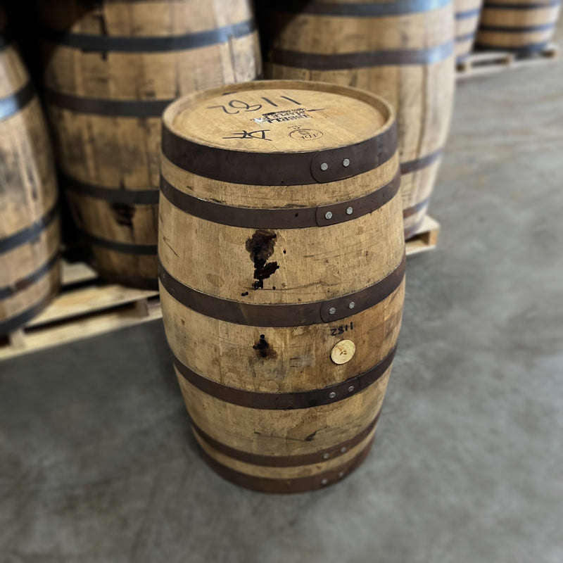Head and side of a 30 Gallon Bissell Maple Syrup Barrel Ex-Bourbon with other used barrels in the background