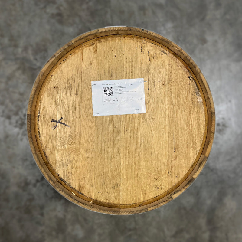 Head of a Cat Head Distillery Chicory Barrel with paper with fill information stapled to the head