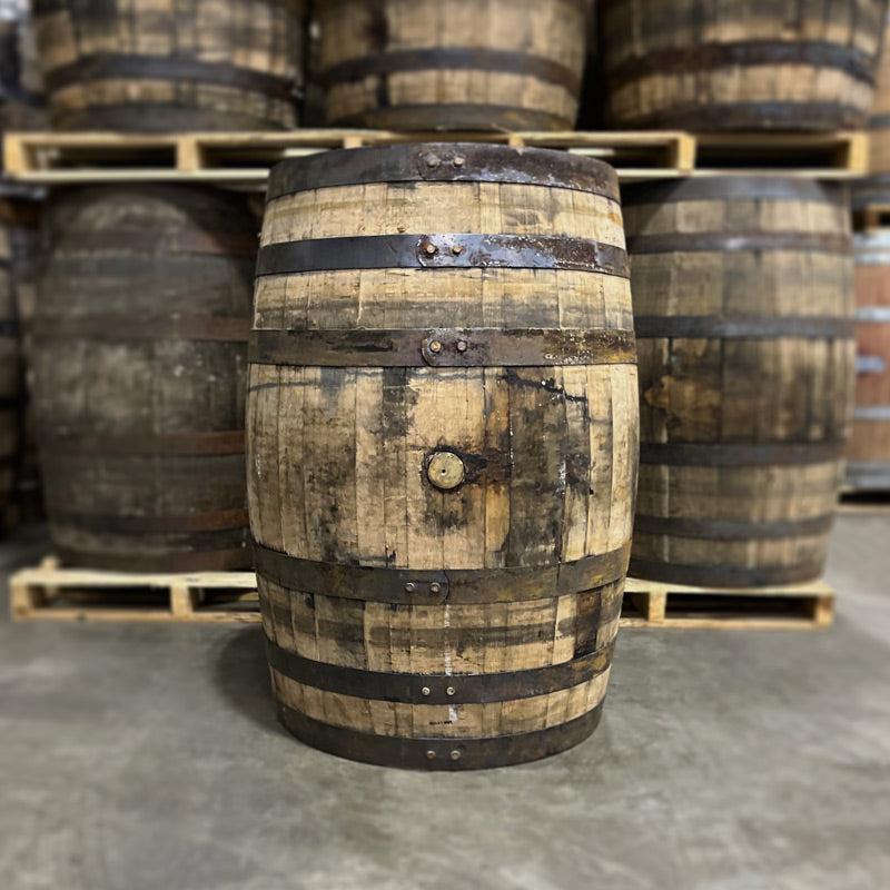 Bunghole side of a Bissell Maple Syrup Barrel and other maple syrup barrels in the background