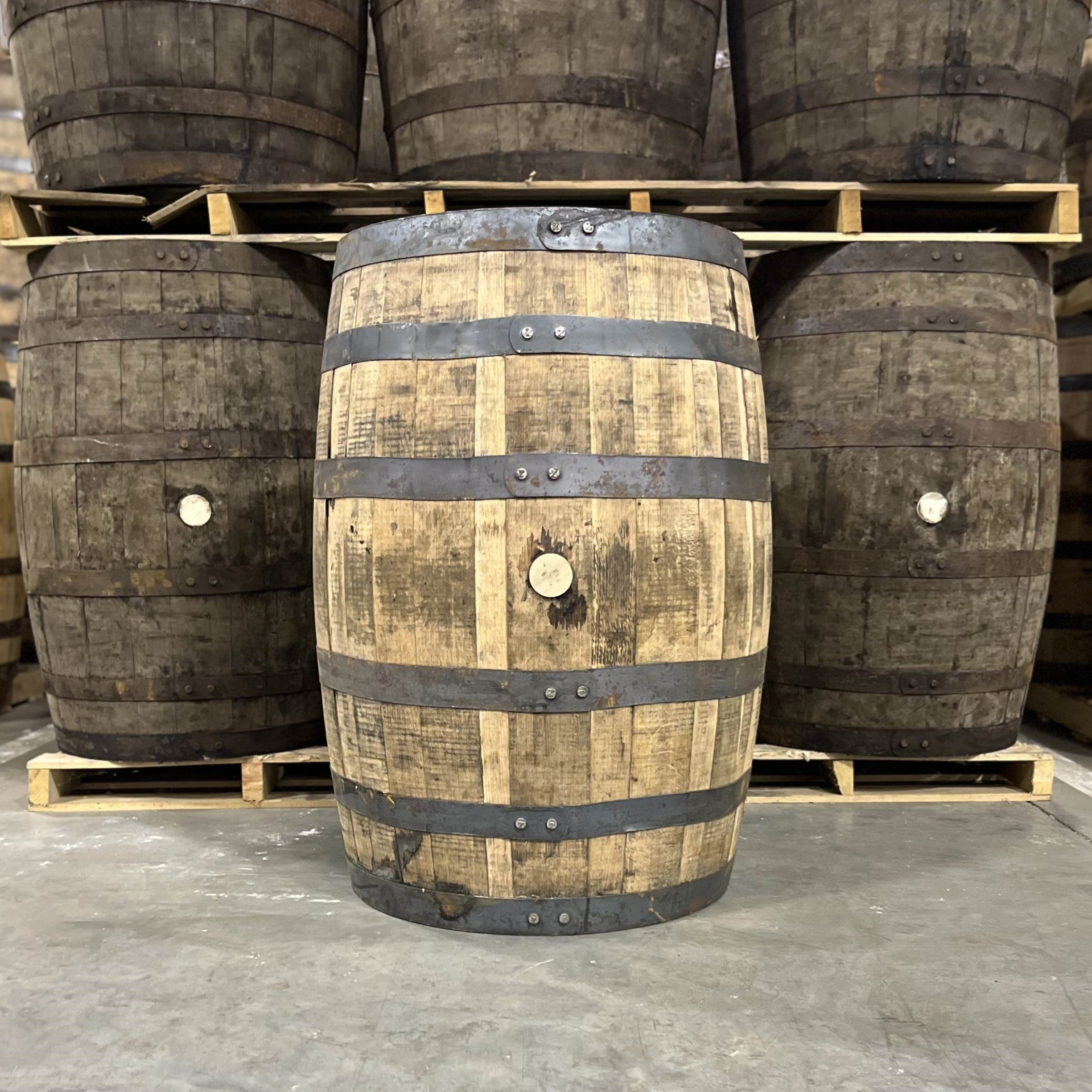 Bunghole side of a Hemingway Rye Whiskey Barrel with other used barrels for sale in the background