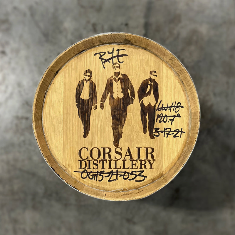 Head of a 15 Gallon Corsair Distillery Rum Barrel with handwritten notes about barrel contents around a stamped image of three men in sunglasses and suits and text Corsair Distillery