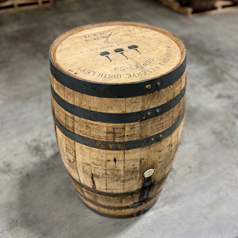 Head and side of a Woodford Reserve Bourbon barrel with distillery information, fill date and three pot stills stamped on the head