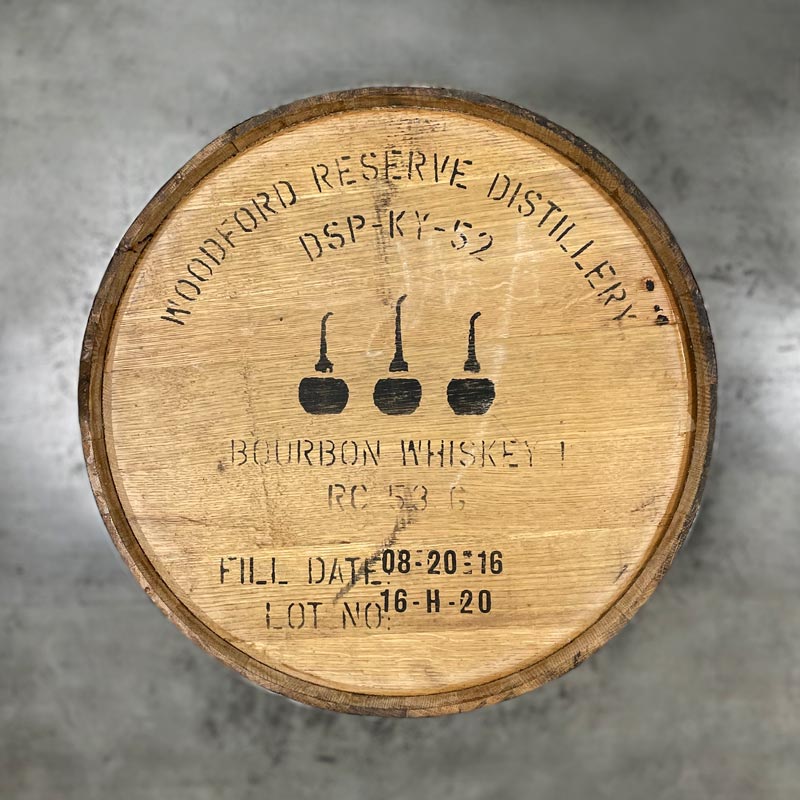 Head of a Woodford Reserve Bourbon barrel with distillery information, fill date and three pot stills stamped on the head