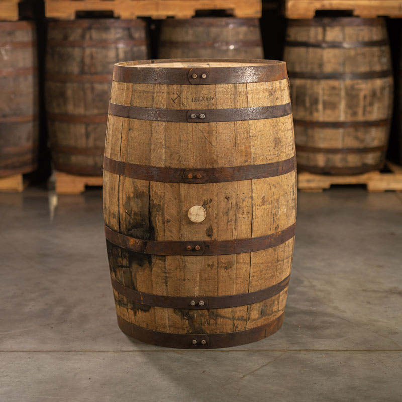 Side of a Templeton 10 Year Reserve Rye Whiskey Barrel with barrels on pallets in the background