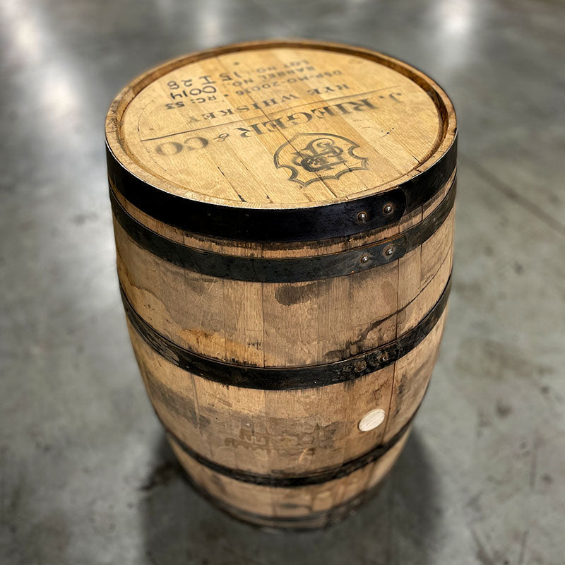 Head and side of a Rieger's Whiskey barrel with distillery markings and stamp on head