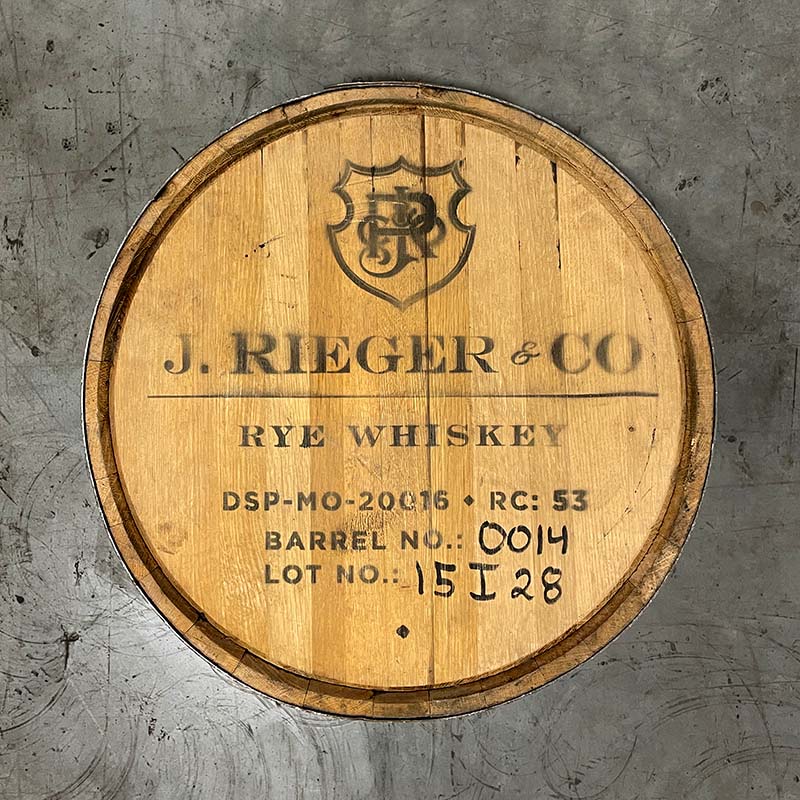 Head of a J Rieger and Co Rieger's Rye Whiskey barrel with shield logo and distillery markings