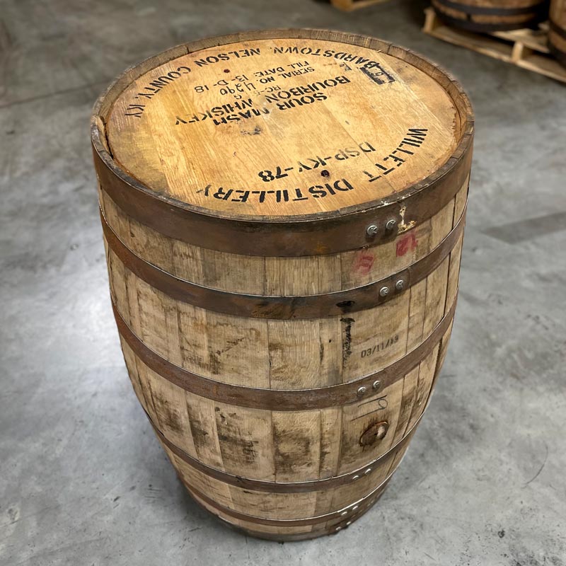 Head and side of a Willett Family Estate Bourbon barrel with distillery stamps on the head and fill date stamped on the side