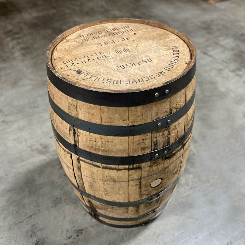 Head and side of a Woodford Reserve Double Oaked Bourbon barrel with distillery name, fill dates and a circle around two barrels stamped on the head