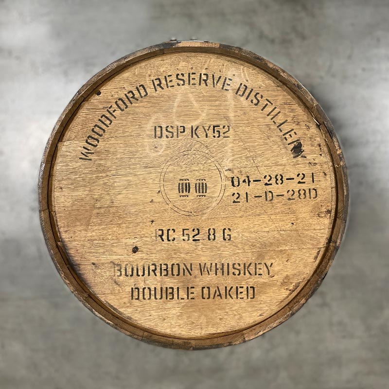 Head of a Woodford Reserve Double Oaked Bourbon barrel with distillery name, number, fill dates and a circle with two barrels inside stamped on the head