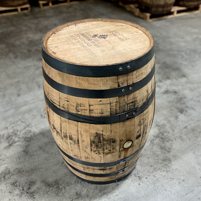 Head and side of an Old Forester 1910 Bourbon Whisky with Woodford Reserve distillery information and OF-1910 stamped on head