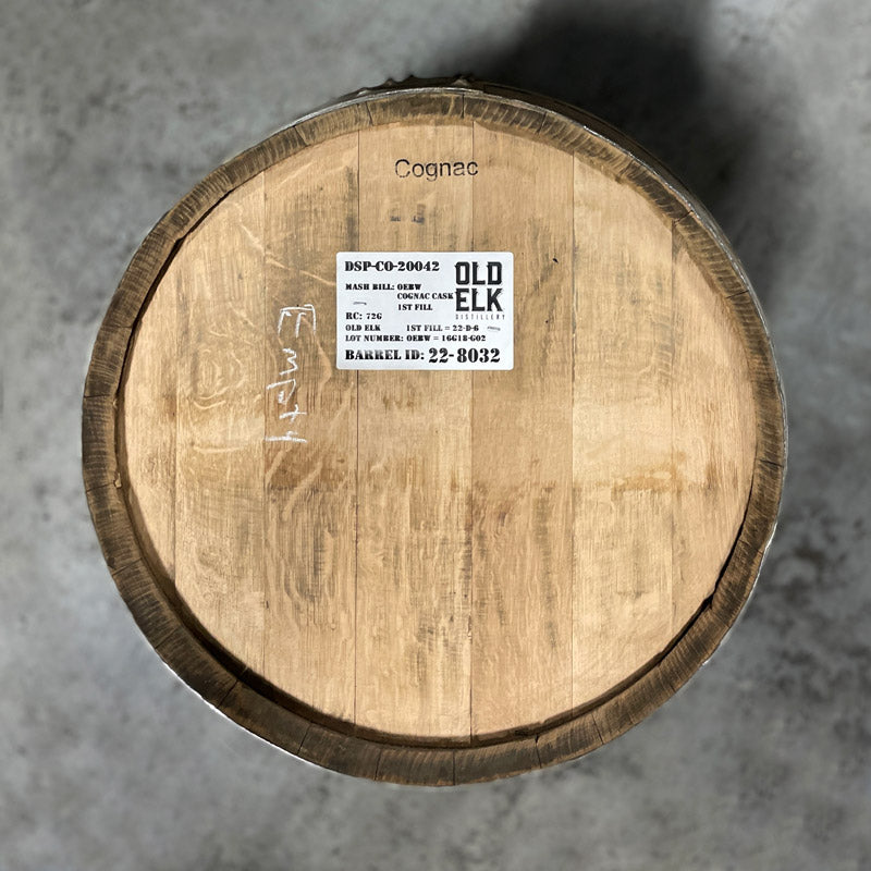 Head of an Old Elk Cognac Finished Bourbon Barrel with Old Elk Distillery sticker on the head and words Cognac and Empty written on the head