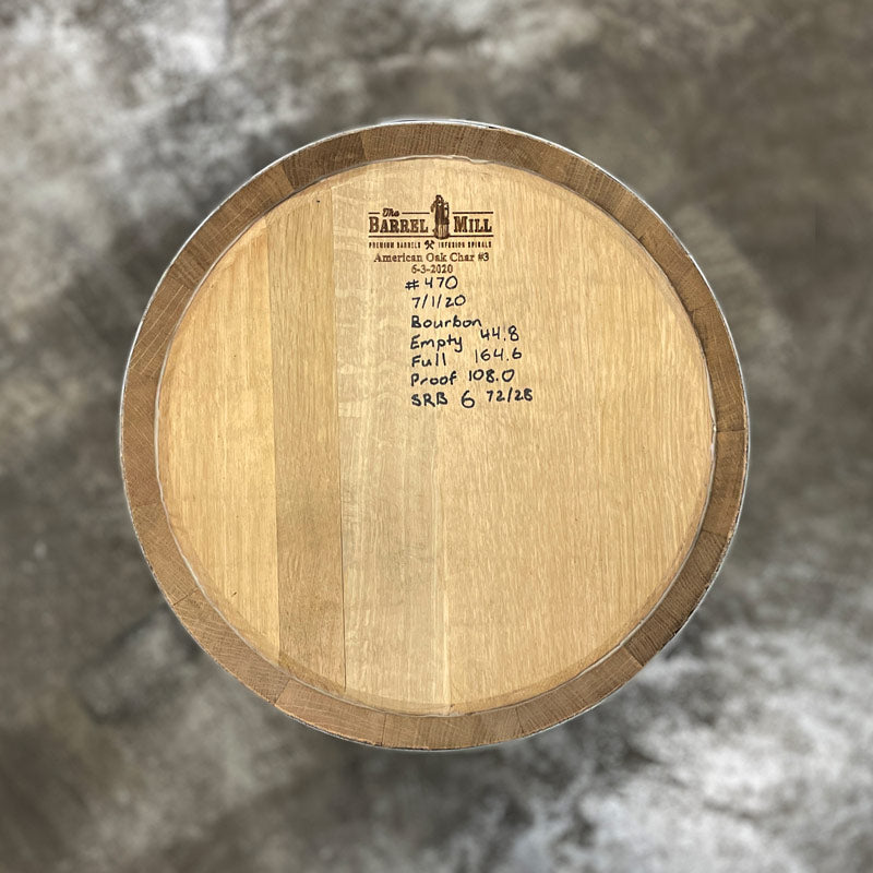 Head of a 15 Gallon Lonely Oak Bourbon Barrel with handwritten notes, including fill date, on the head