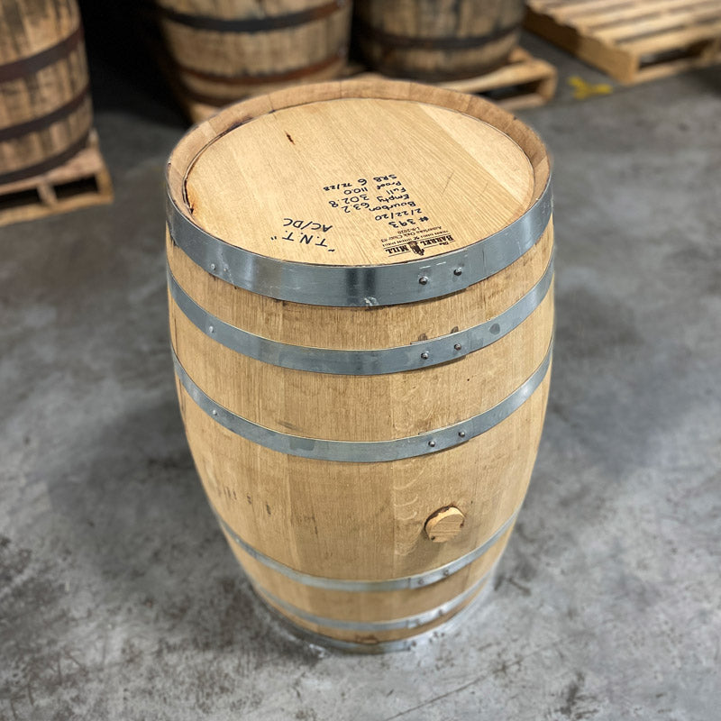 Head and side of a 30 Gallon Lonely Oak Bourbon Barrel with other barrels in the background