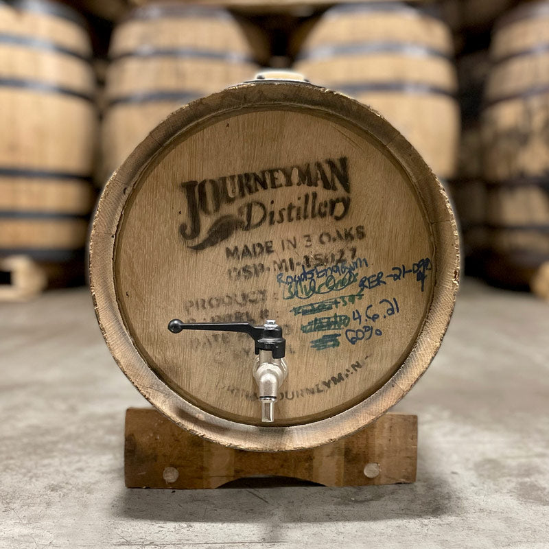 Head of a 5 Gallon Journeyman Rum Barrel (ex-whiskey) with distillery information stamped on the head, a spigot and stand.