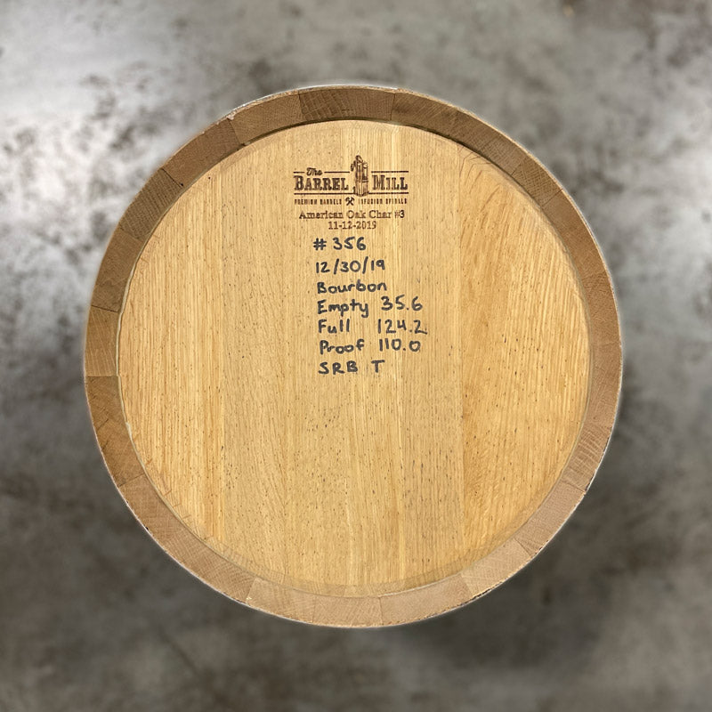 Head of a 10 Gallon Lonely Oak Bourbon Barrel with handwritten fill date, spirit information and other notes on the head.