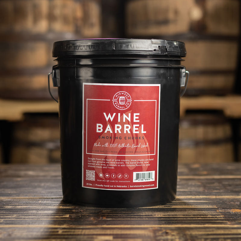 A bucket of Wine Barrel BBQ Smoking Wood Chunks with used barrels stacked in the background