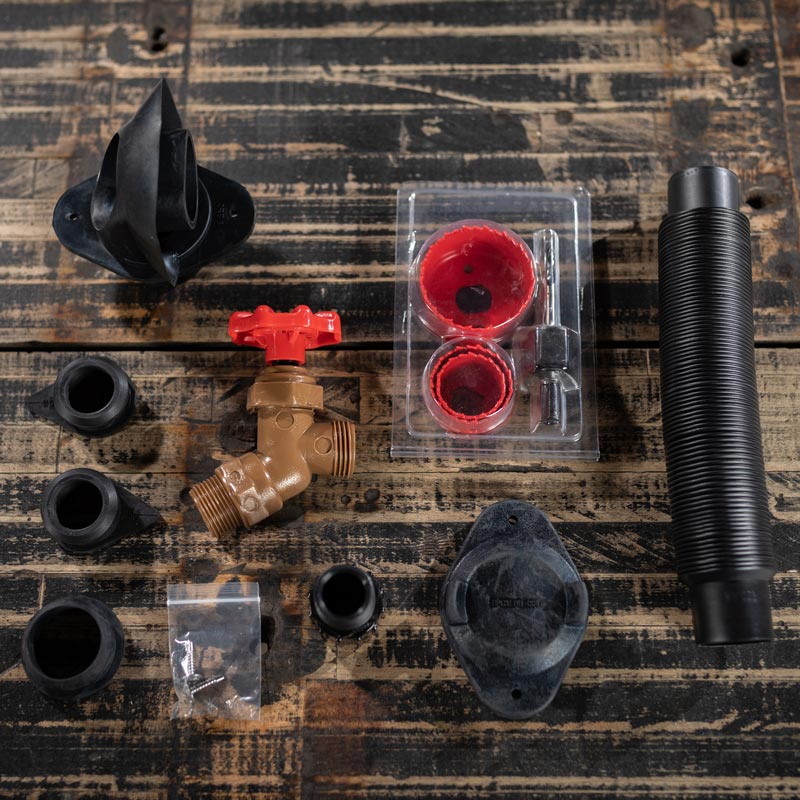 DIY rain barrel kit parts laid out on table