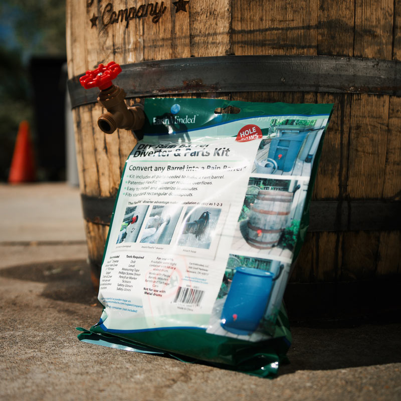 DIY Rain Barrel Kit bag leaning against rain barrel with spigot