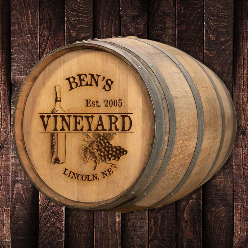 Full size engraved wine barrel with text Ben's Vineyard Est. 2005 Lincoln, NE and design with wine bottle, wine glass and bunch of grapes and text Midwest Barrel Co. Est. 2015