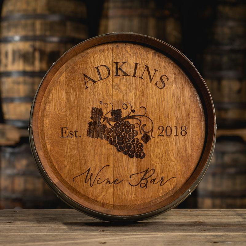 Engraved barrel head with text Adkins Wine Bar Est. 2018 and a image of grapes