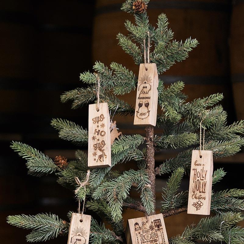 Engraved barrel ornaments hanging on a Christmas tree