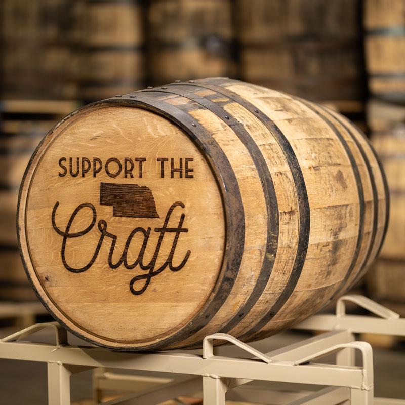 Laser engraved full size whiskey barrel with Support the Craft and image of Nebraska on barrel head