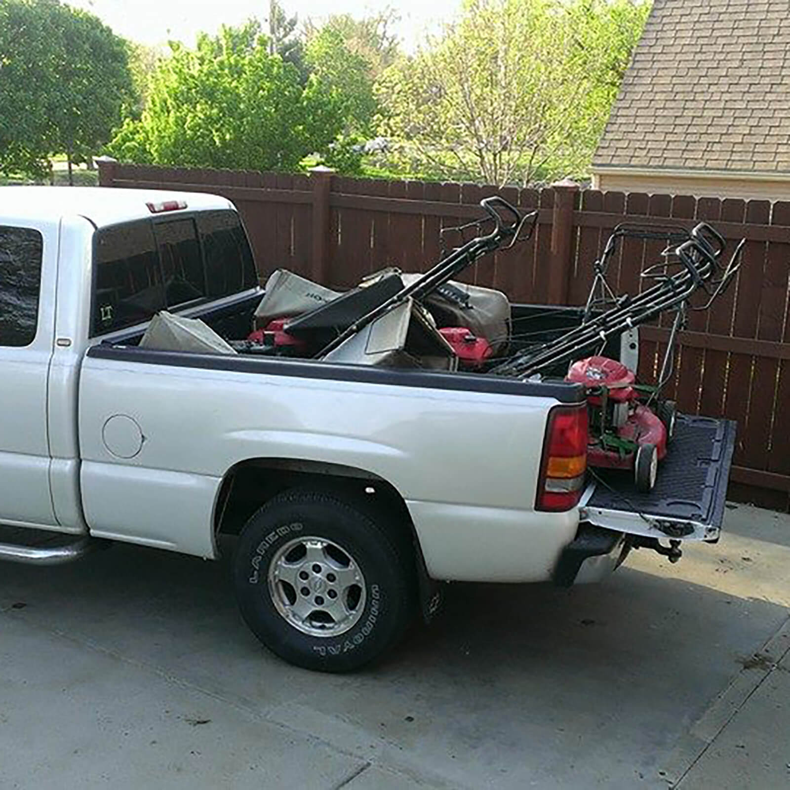Pickup truck with lawnmowers in back