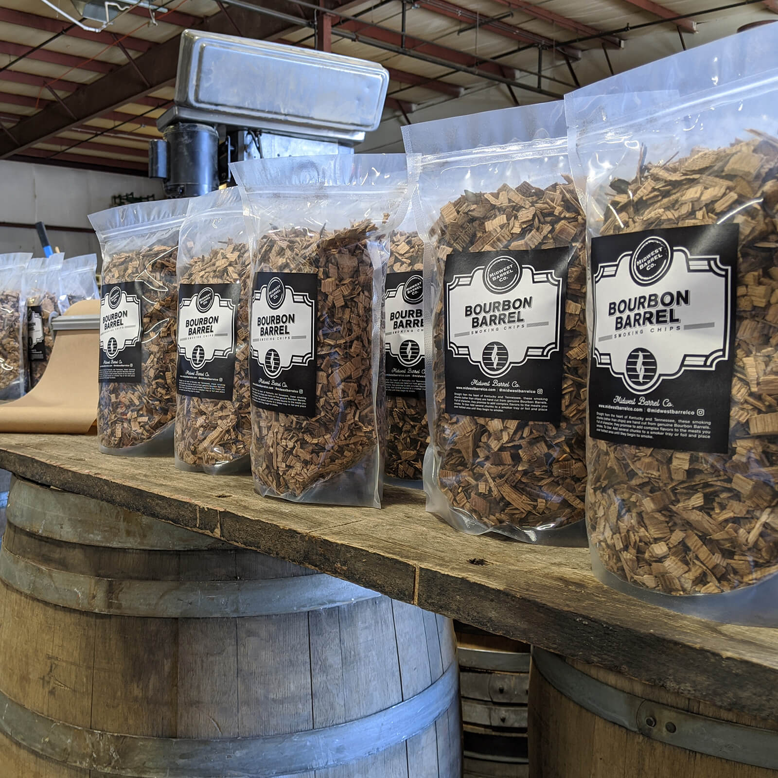 Bags of Bourbon Barrel BBQ Smoking Wood chips on table in warehouse