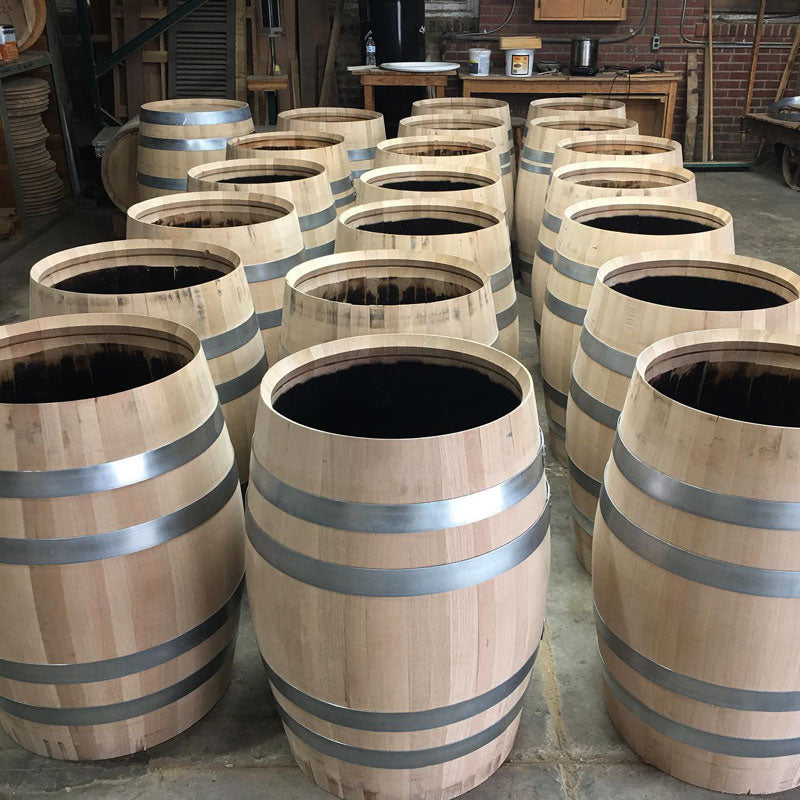 Three rows of brand new full size 53 gallon American white oak barrels with no heads and charred interiors