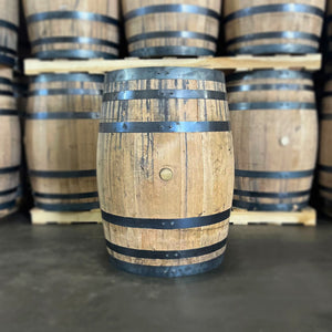 
                  
                    Brand new, never used American white oak whiskey barrel with belly bung side showing and other barrels on pallets in the background
                  
                