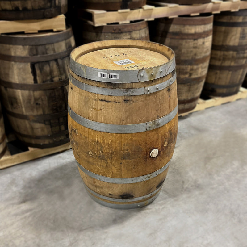 
                  
                    Head and side of a Bardstown Bourbon Co. Wine Cask Finished Bourbon Barrel with other used bourbon barrels for sale on pallets in the background
                  
                