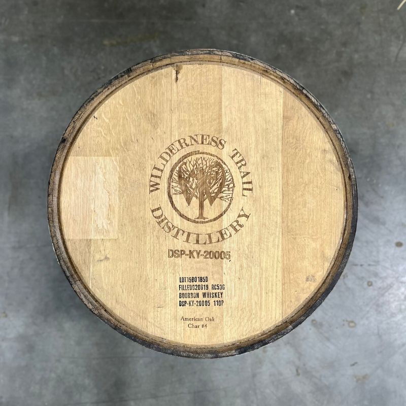 Head of a Wilderness Trail Wheated Bourbon Barrel with Wilderness Trail Distillery Tree, W and circle logo engraved on the head