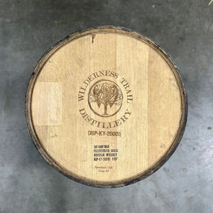
                  
                    Head of a Wilderness Trail Wheated Bourbon Barrel with Wilderness Trail Distillery Tree, W and circle logo engraved on the head
                  
                