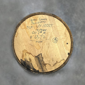 
                  
                    Head of a Kings County Peated Bourbon Barrel with distillery information handwritten on the head
                  
                