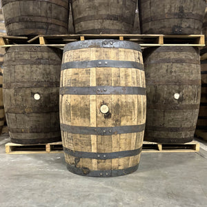 
                  
                    Bunghole side of a Hemingway Rye Whiskey Barrel with other used barrels for sale in the background
                  
                