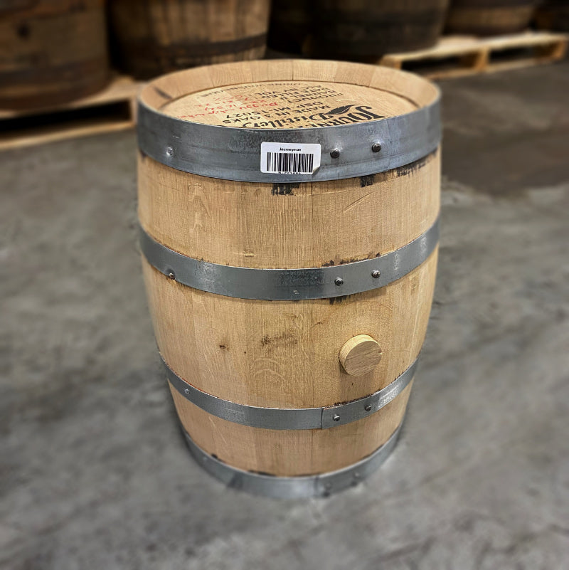 
                  
                    Head and side of a 5 gallon Journeyman Wheat Whiskey Barrel with other used whiskey barrels in the background
                  
                