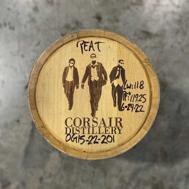 Head of a 15 Gallon Corsair Distillery Peated Whiskey Barrel with stamp of Corsair Distillery name and three men dressed in suits and sunglasses