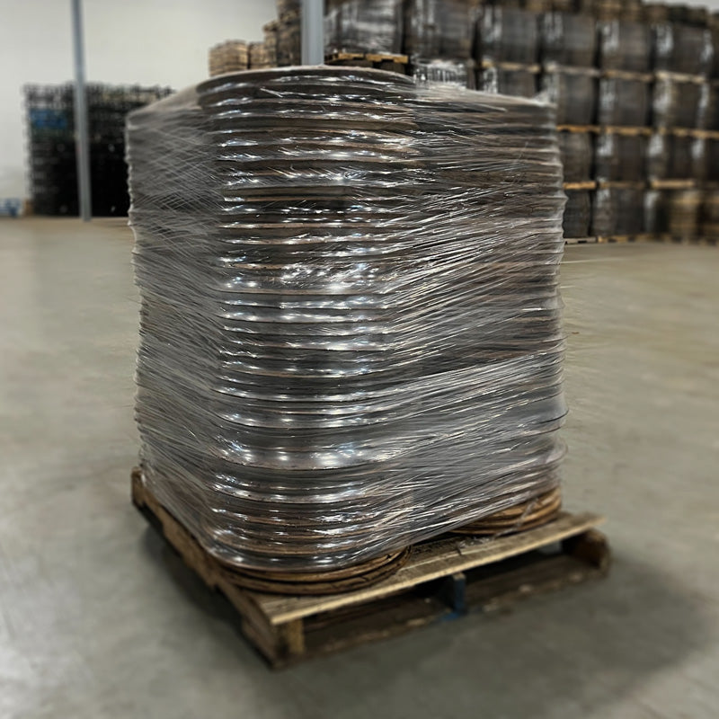 
                  
                    A pallet of bourbon and whiskey barrel heads on a pallet wrapped in plastic wrap
                  
                