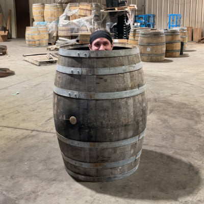 Mitch inside whiskey barrel with head removed