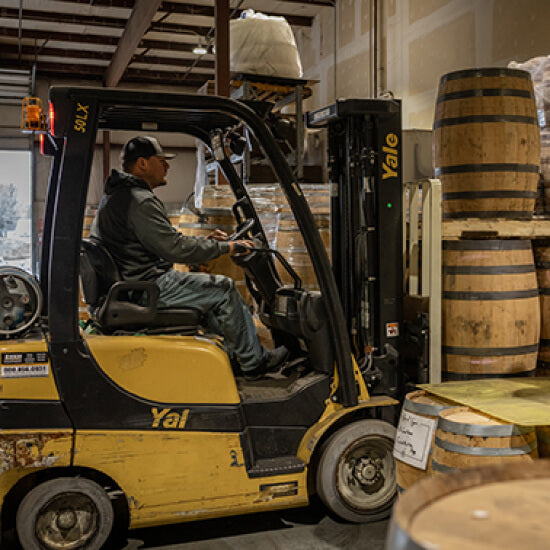 Midwest Barrel Co. employee driving forklift
