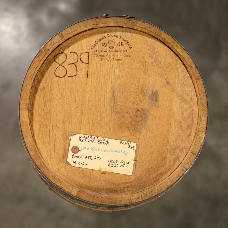 Head of a 15 Gallon Wood Hat Whiskey Barrel with McGinnis Wood Products cooperage name and logo engraved on the barrel plus a sticker with whiskey information from the distillery on the head