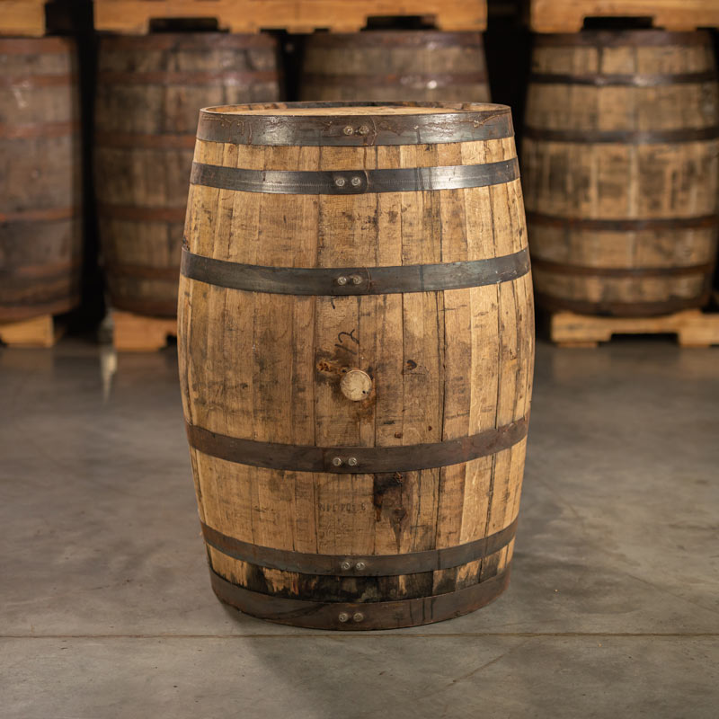 Side of a 1792 Bourbon Barrel with barrels stacked on pallets in the background