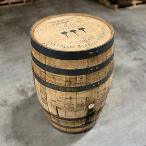 
                  
                    Head and side of a Woodford Reserve Bourbon barrel with distillery information, fill date and three pot stills stamped on the head
                  
                