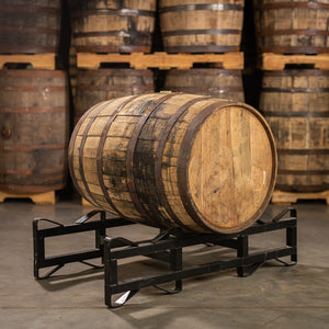 
                  
                    A Templeton 10 Year Reserve Rye Whiskey Barrel laying on a barrel rack with barrels stacked on pallets in the background
                  
                
