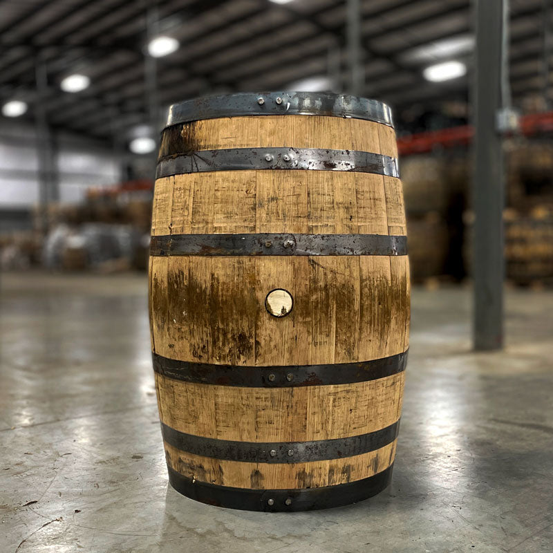 
                  
                    Side view of a Next Century Spirits Young Bourbon Barrel with rusted rings and stained wood
                  
                