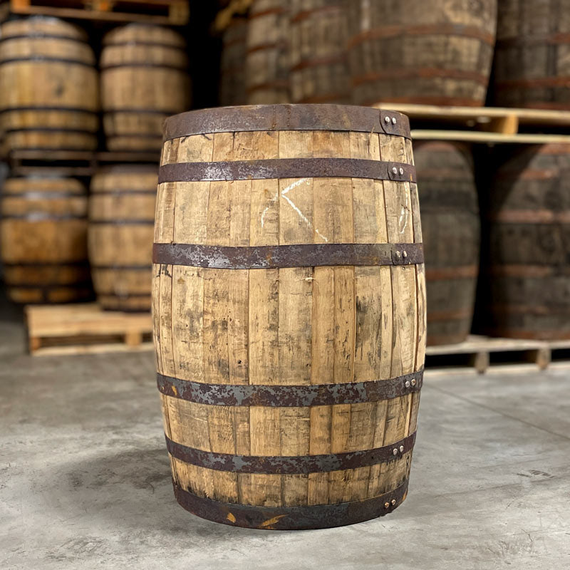 Side view of Templeton Rye Whiskey Barrel and barrels on pallets in the background