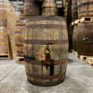 
                  
                    Side of an 18 Year Elijah Craig Bourbon Barrel with barrels stacked on pallets in the background
                  
                