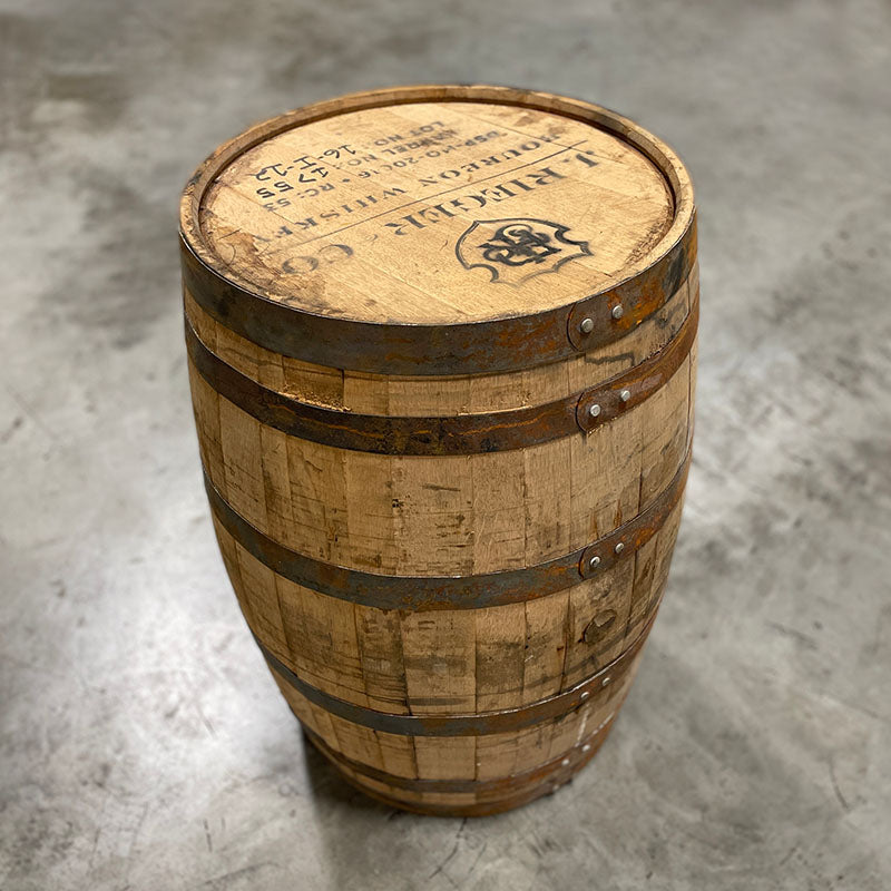 
                  
                    Head and side of J Rieger and Company Rieger's Kansas City Whiskey barrel with shield logo and distillery markings on the head
                  
                