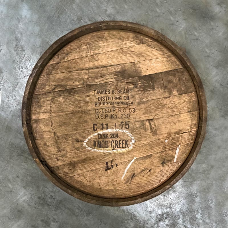 Head of a 10-Year Knob Creek Bourbon barrel with James B Beam distillery stamps and Knob Creek labeled on head