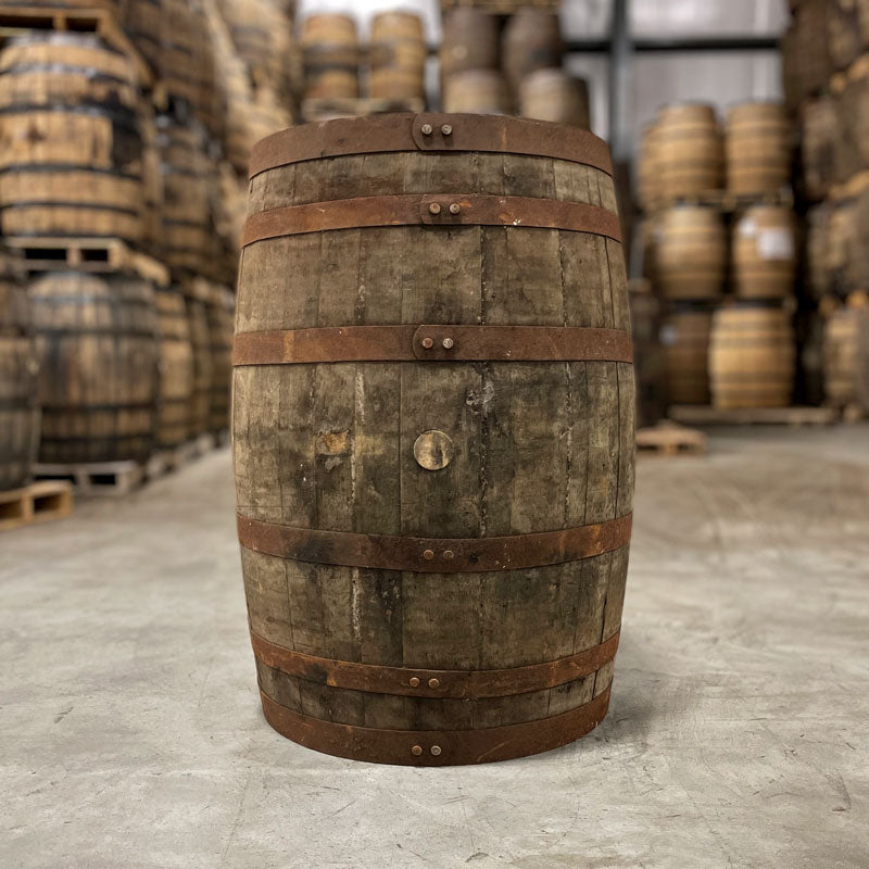 
                  
                    Side of a 10 Year Buffalo Trace Mash 1 Bourbon Barrel with barrels on pallets in the background
                  
                